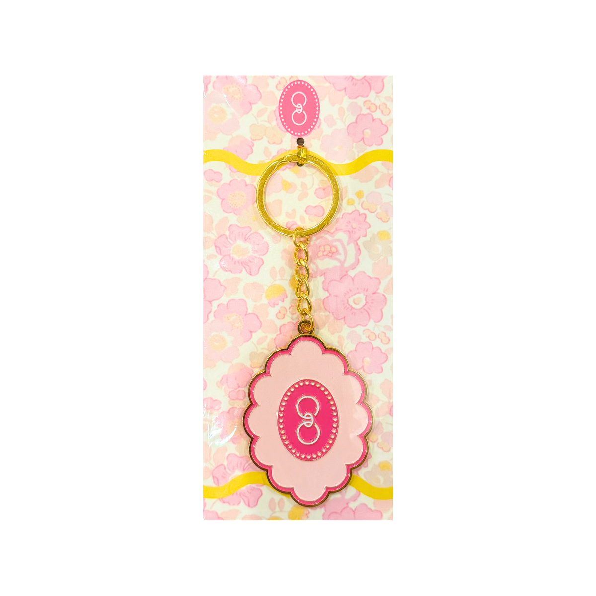 Pink scallop logo keychain attached to a gold key ring
