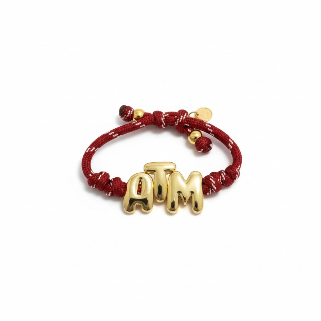 Maroon paracord bracelet with gold ATM letters