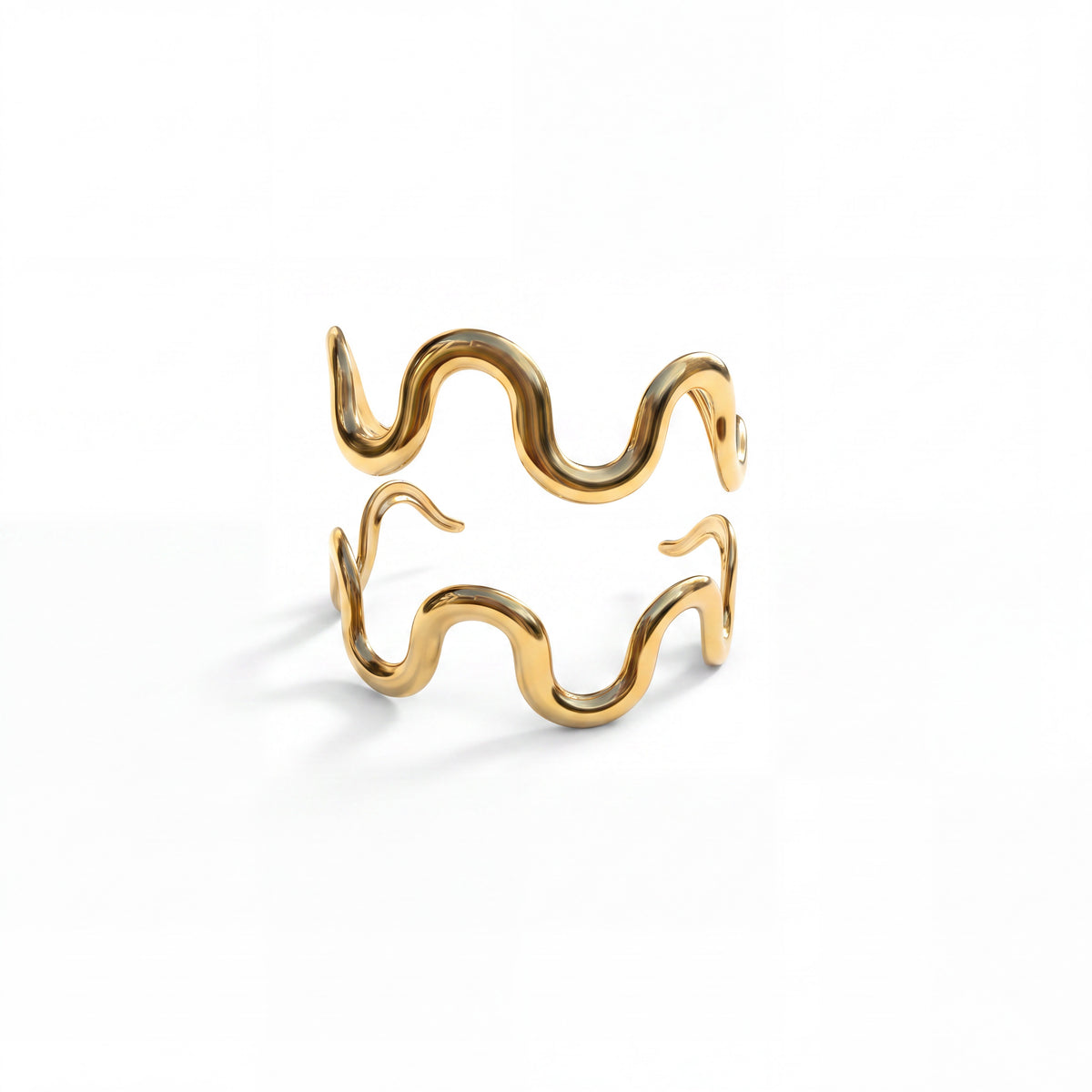 Two gold Onda wave cuffs stacked together