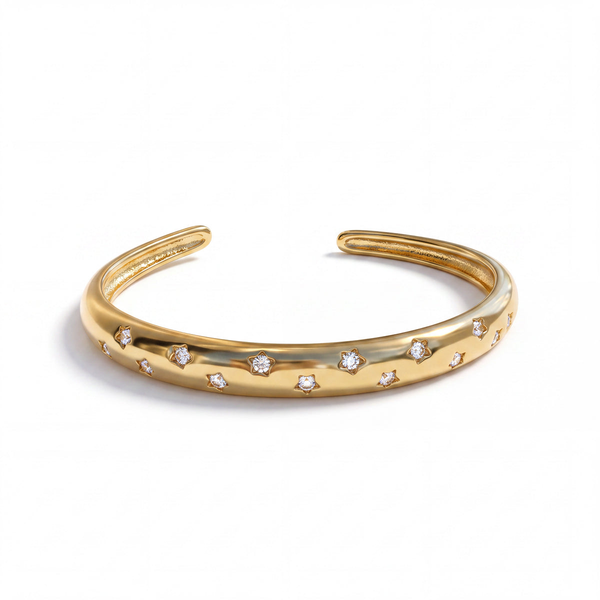 Gold tone Stella cuff with star details and an open design