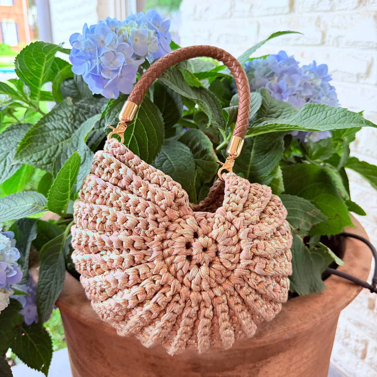 Tan Nautilus crochet shell handbag with a rounded handle
