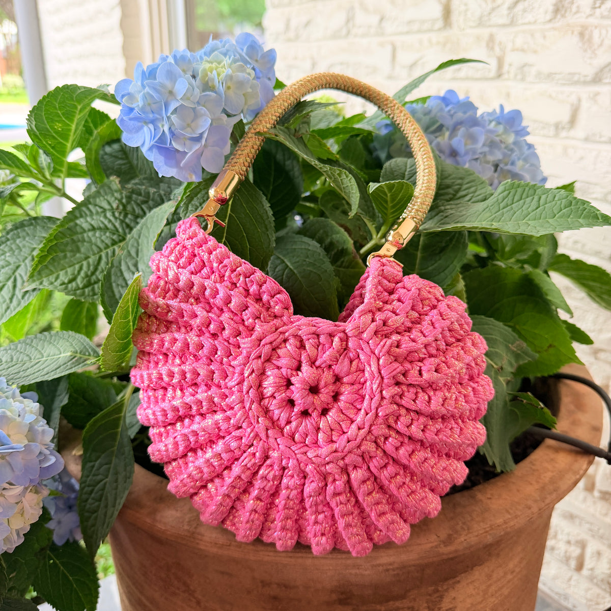 Hot pink Nautilus crochet shell handbag with a rounded handle