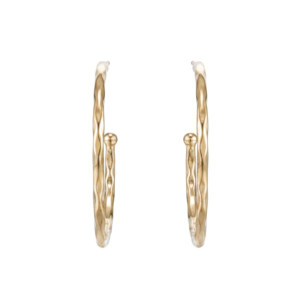 Large gold Mia hoop earrings shown from the side