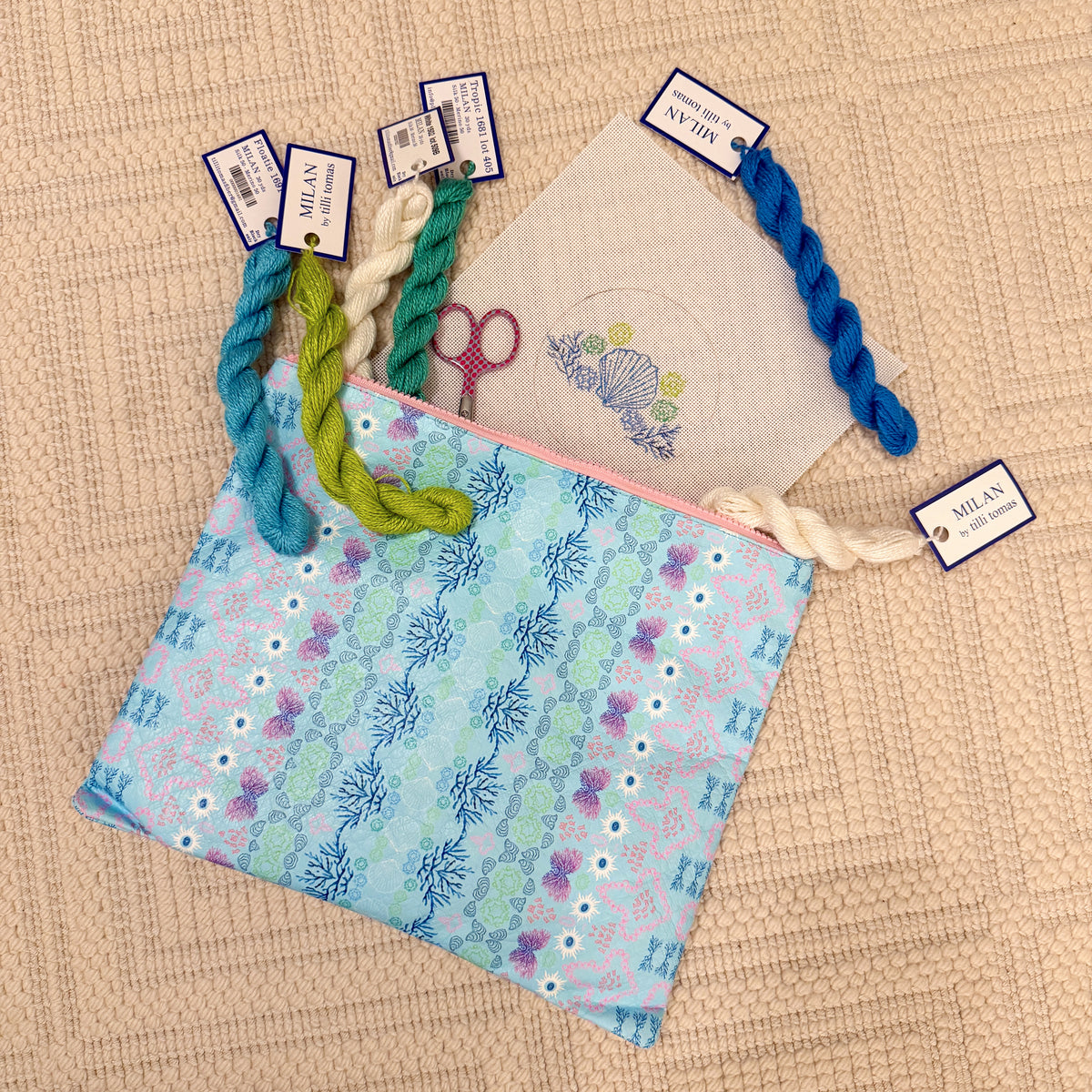 Coastal print zipper bags beside colorful paracord bracelets