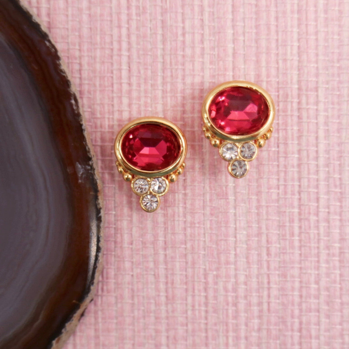 Ruby colored BonBon stud earrings in gold settings