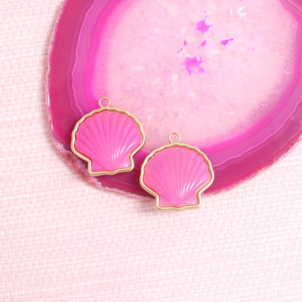 Pink Peregrina scallop shell earring charm pair on a pink agate slice