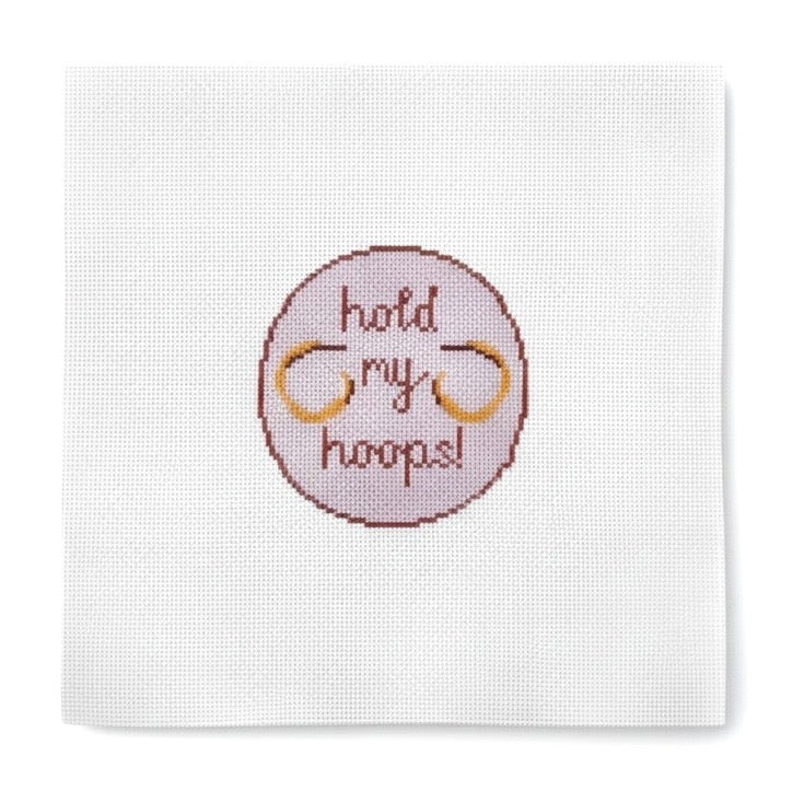 Hold My Hoops lettering needlepoint design on a pink circle