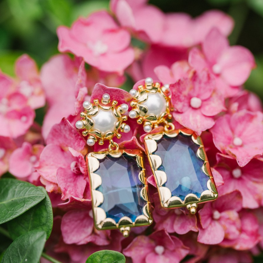 Azure blue Mini Gemma earrings arranged on pink hydrangeas