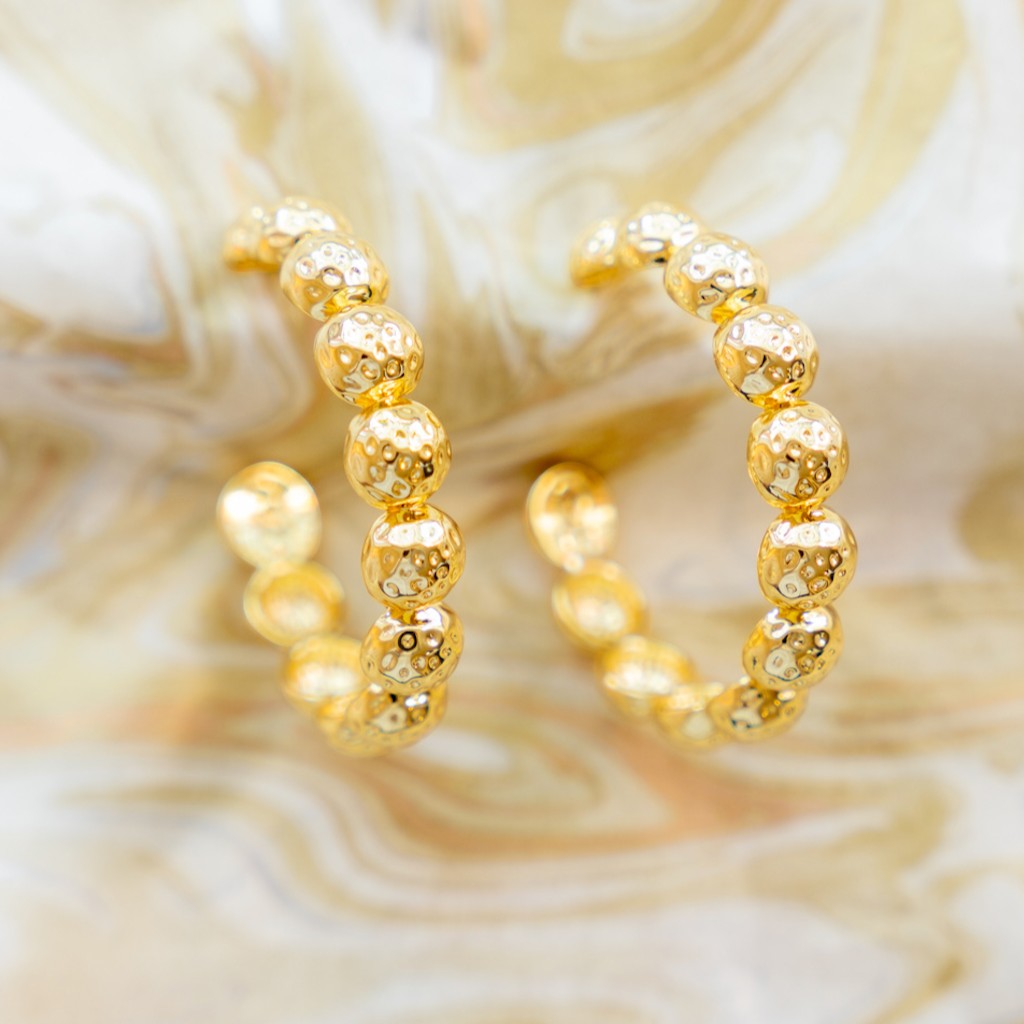 Close-up of textured gold Florence hoops