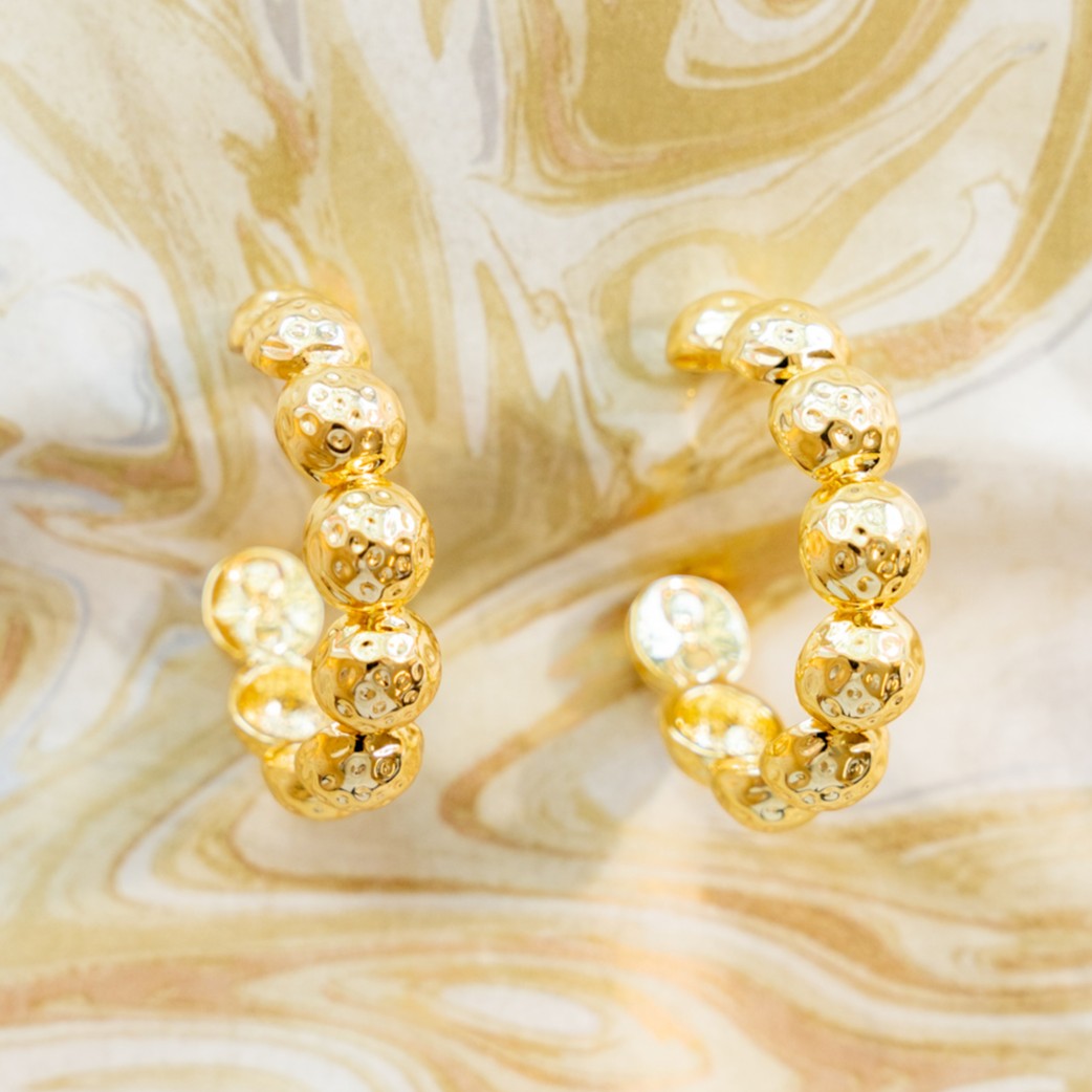 Close-up of textured gold Florence hoops