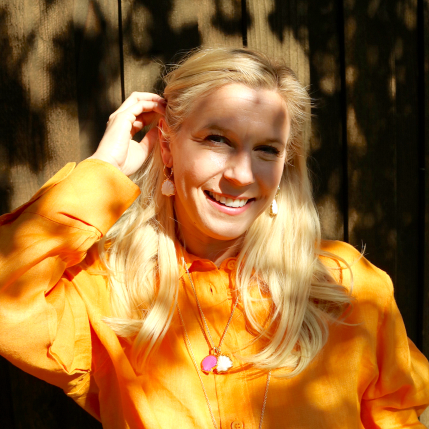 Woman wearing Peregrina Shell Charm by Gresham Jewelry