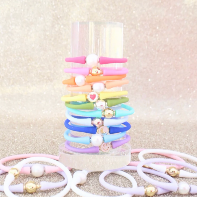 Mini clear bracelet tower stacked with colorful silicone bracelets