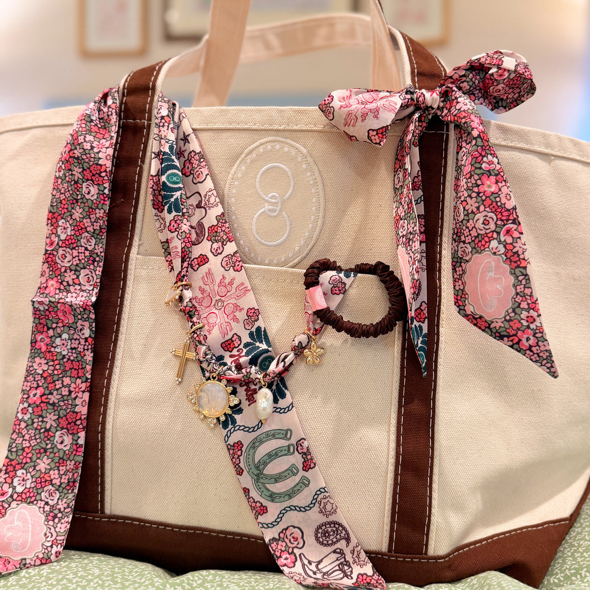 Canvas tote with brown straps styled with scarves and accessories