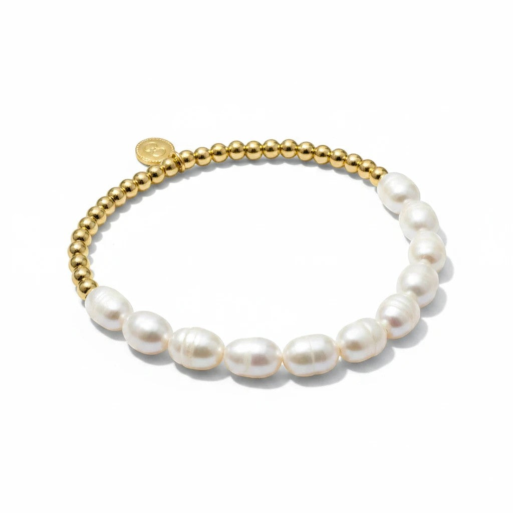 Gresham Anna stretch bracelet featuring gold beads and white freshwater pearls with a small branded charm.