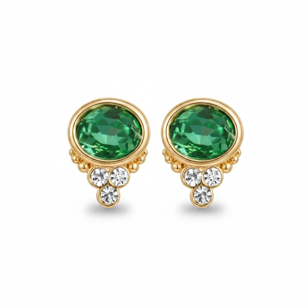 Gresham BonBon emerald stud earrings featuring oval green crystals and small clear accent stones in gold settings.