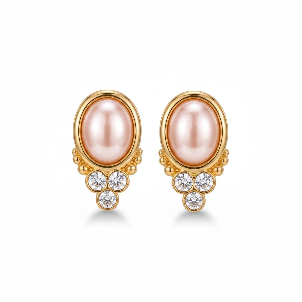 Gresham BonBon pearl stud earrings featuring a pink oval pearl accented with three clear crystals in gold settings.
