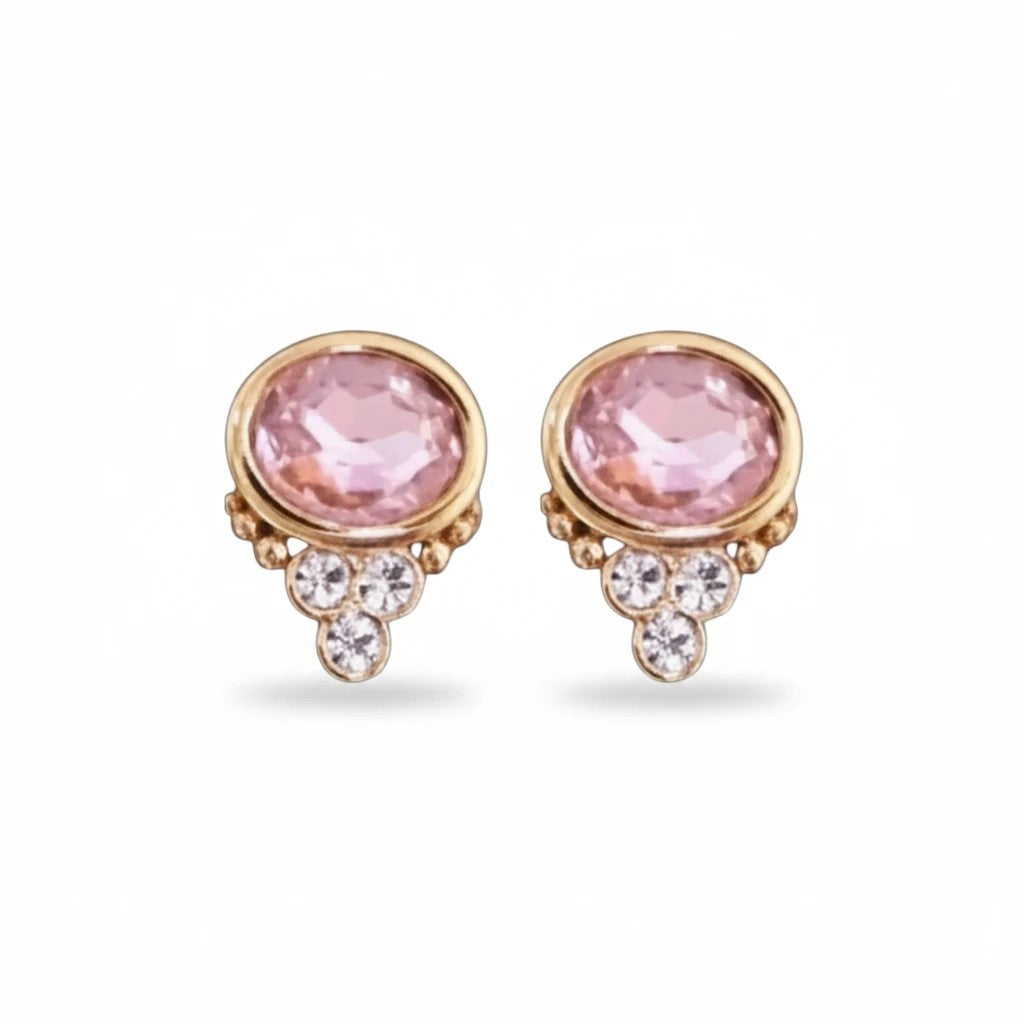 Gresham BonBon stud earrings featuring oval rose quartz stones accented with small clear crystals in gold settings.