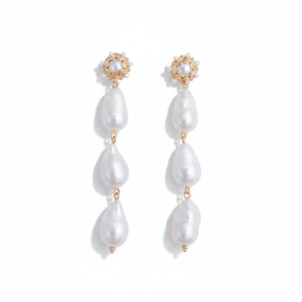 Gresham Clio large drop earrings featuring three organic freshwater baroque pearls with gold floral stud accents.