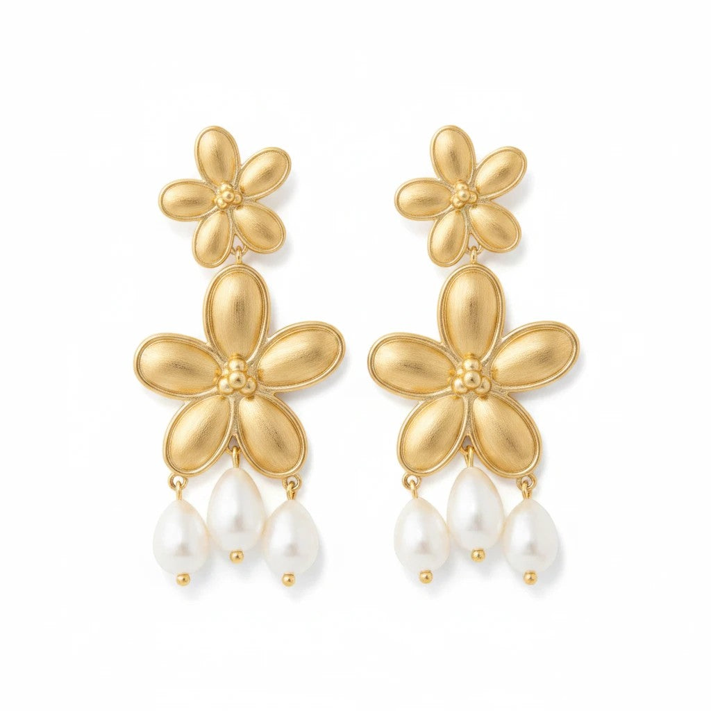 Gresham Flora earrings featuring 18k gold plated flower motifs with dangling freshwater pearls, 2.5 inches long.