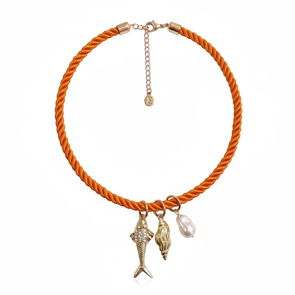 Gresham Jingle necklace featuring an orange twisted silk rope with gold-plated fish, shell, and pearl charms.