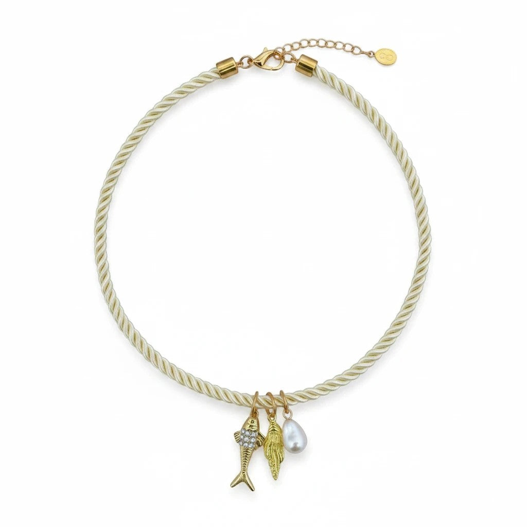Gresham Jingle necklace featuring a cream twisted silk rope with three gold-plated charms and a pearl pendant.