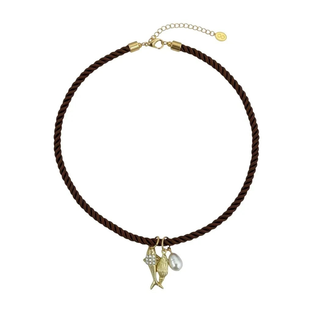 Gresham Jingle necklace featuring a brown twisted silk rope cord with three gold-plated charms and a pearl accent.