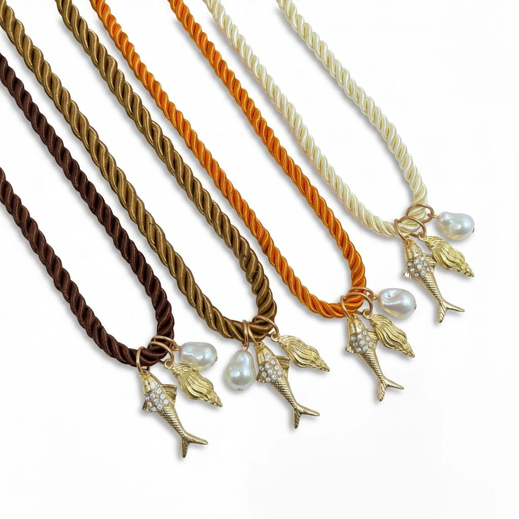 Gresham Jingle necklaces featuring twisted silk rope in various colors with gold plated fish and pearl charms.
