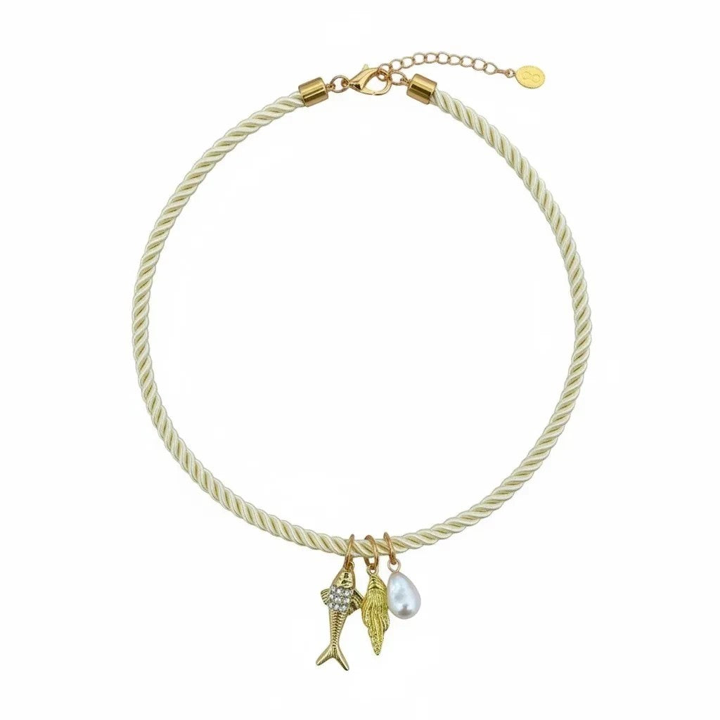 Gresham Jingle necklace featuring a cream twisted silk rope with three gold-plated charms and a pearl pendant.