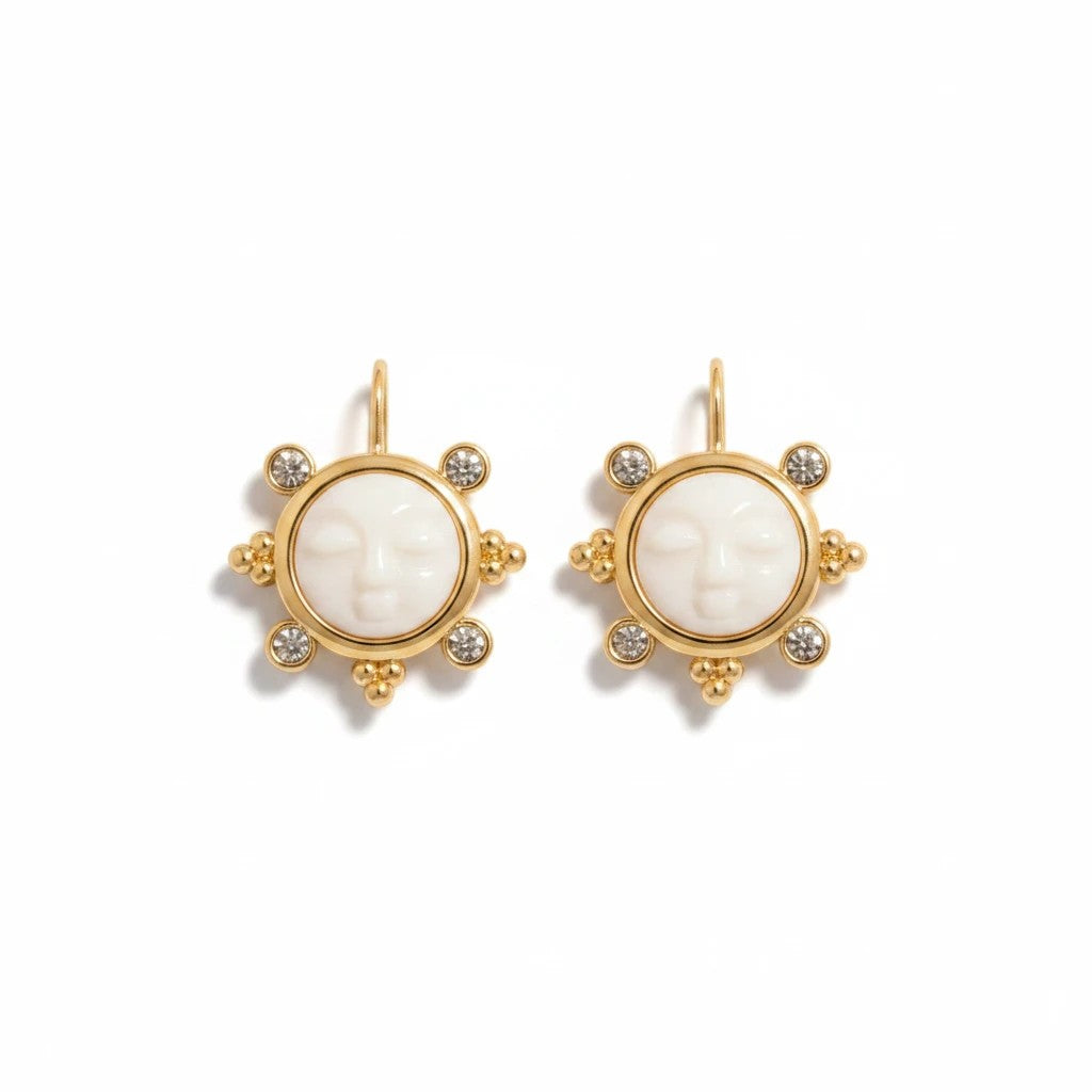Gresham Luna earrings featuring a white moon face cameo set in gold with sparkling crystal accents.