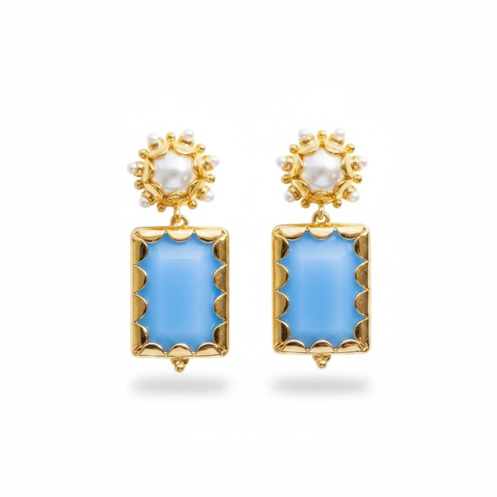 Gresham Mini Gemma Mystic earrings featuring light blue rectangular stones, gold scalloped frames, and pearl accents.