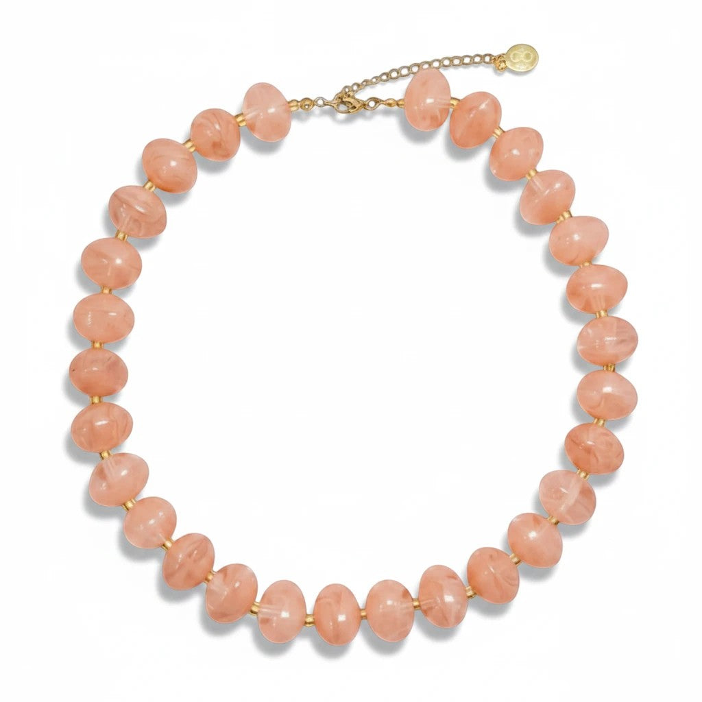 Gresham Nardo pink statement necklace featuring large resin beads with a gold-tone extender chain.