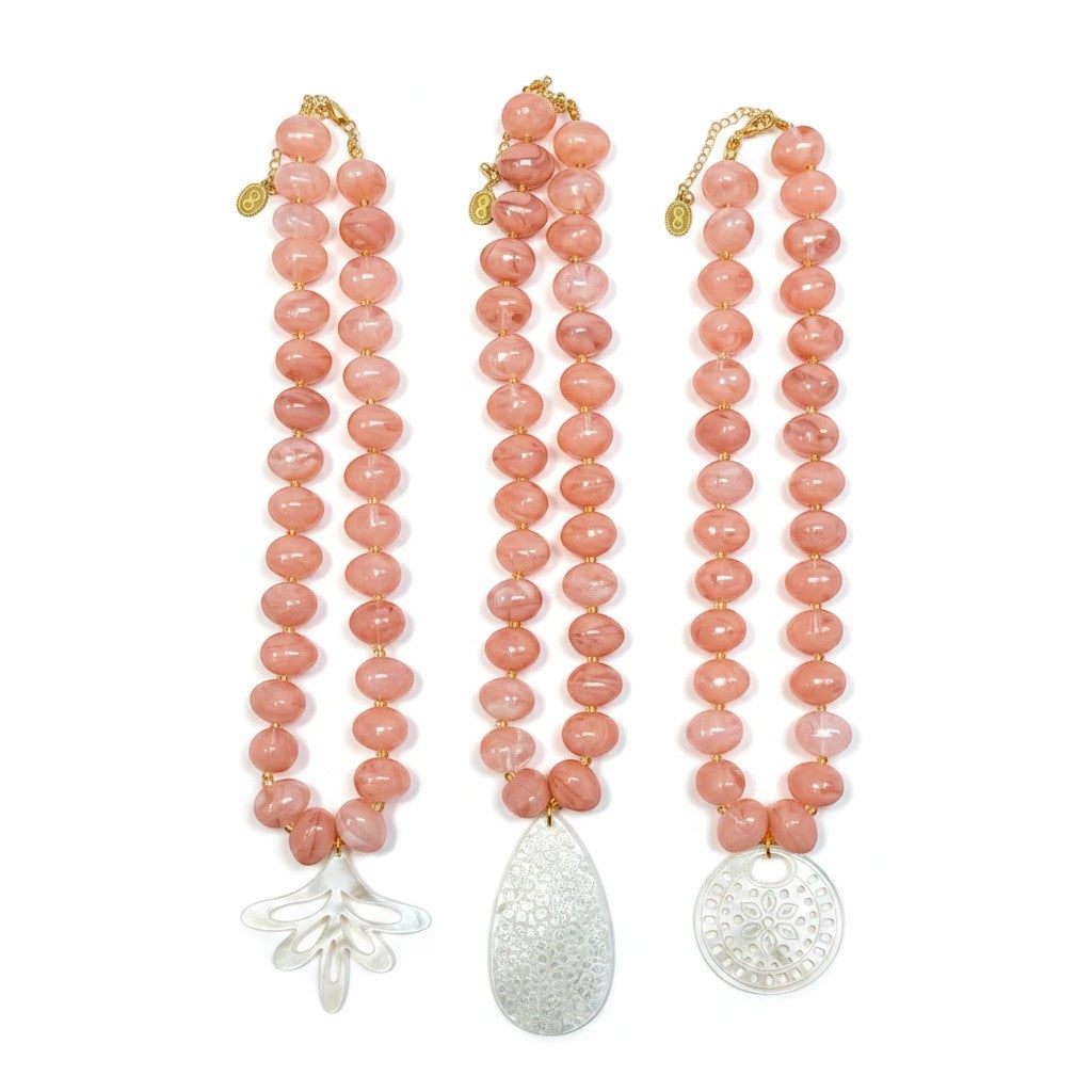 Gresham Nardo pink resin bead necklace set featuring three unique mother-of-pearl pendants on a white background.