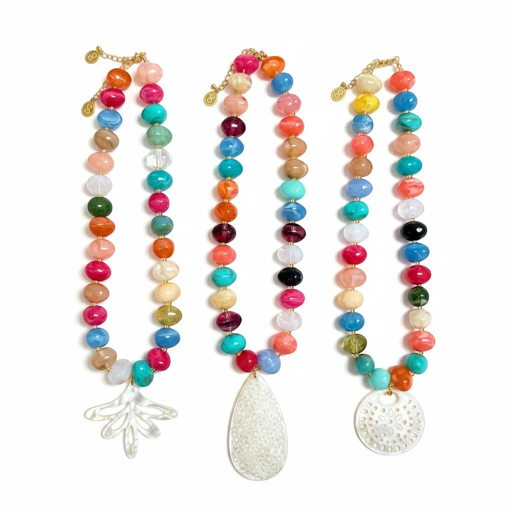 Gresham Nardo rainbow resin bead necklaces with intricate mother-of-pearl pendants on a white background.