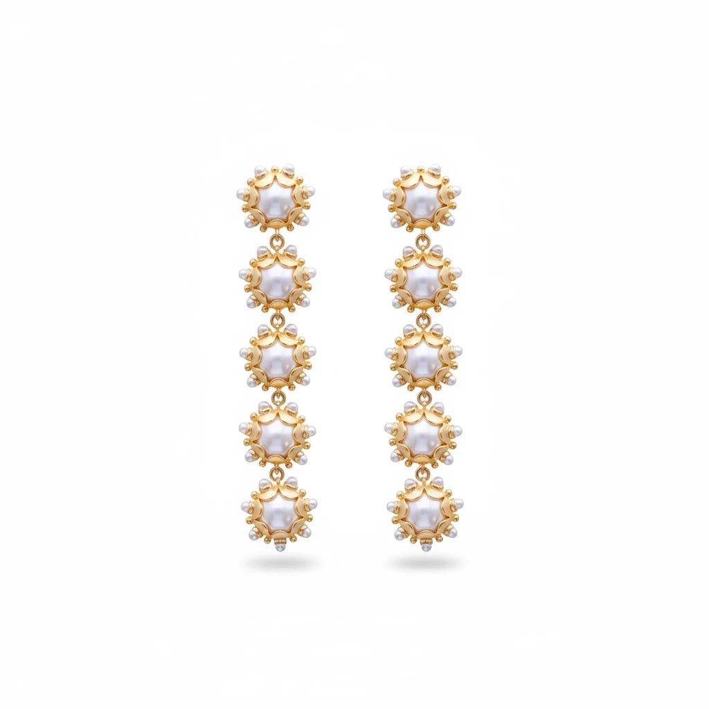 Gresham Perla drop earrings featuring five 18k gold plated floral motifs with pearl accents in a vertical design.