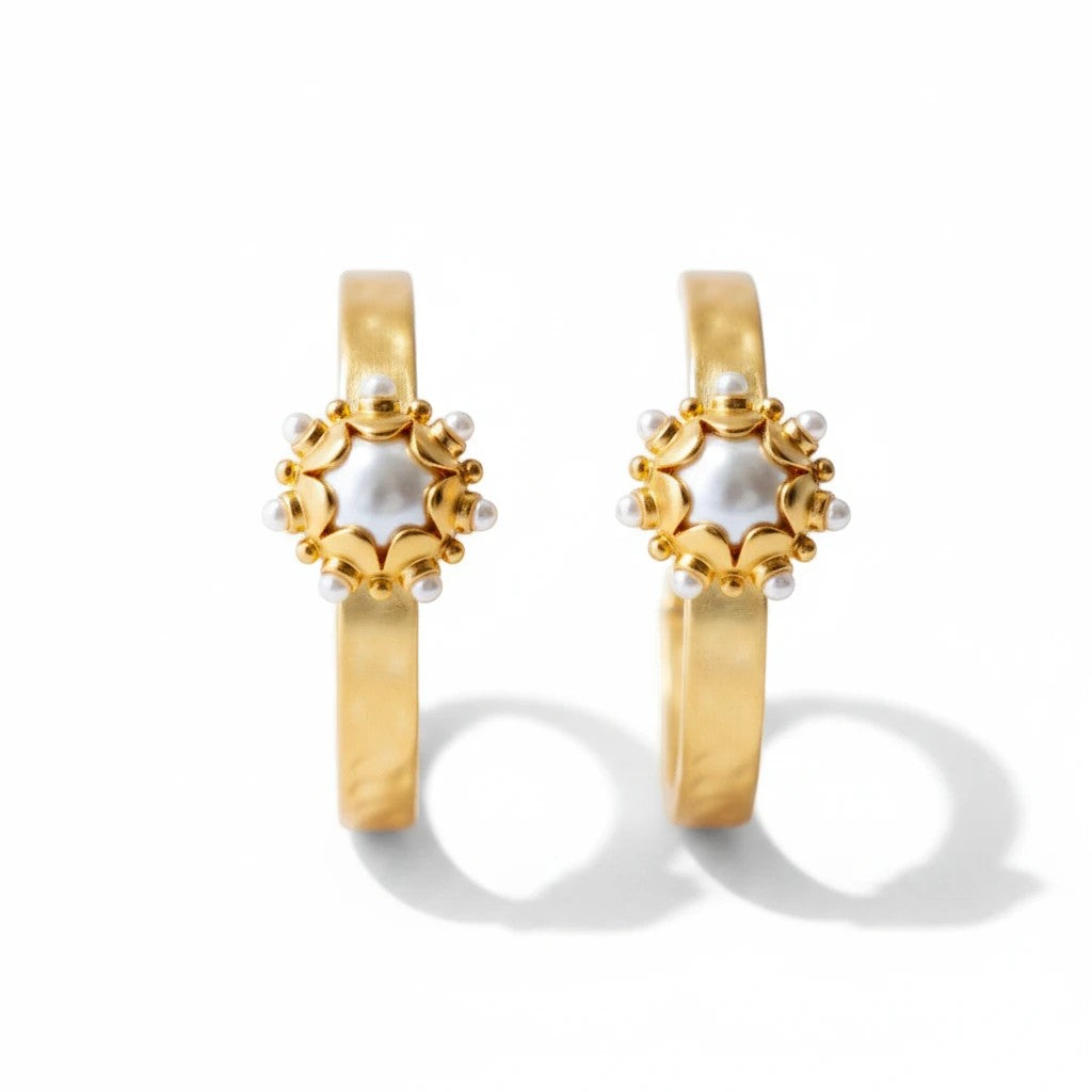 Gresham Perla gold hoop earrings featuring hammered metal, central pearls, and decorative granule details.