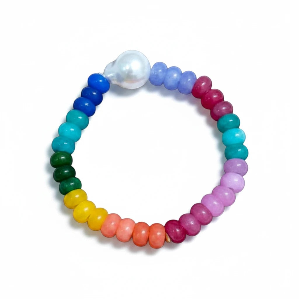 Gresham Tropez Bracelet featuring multi-colored jade beads and a single white pearl on an elastic band.