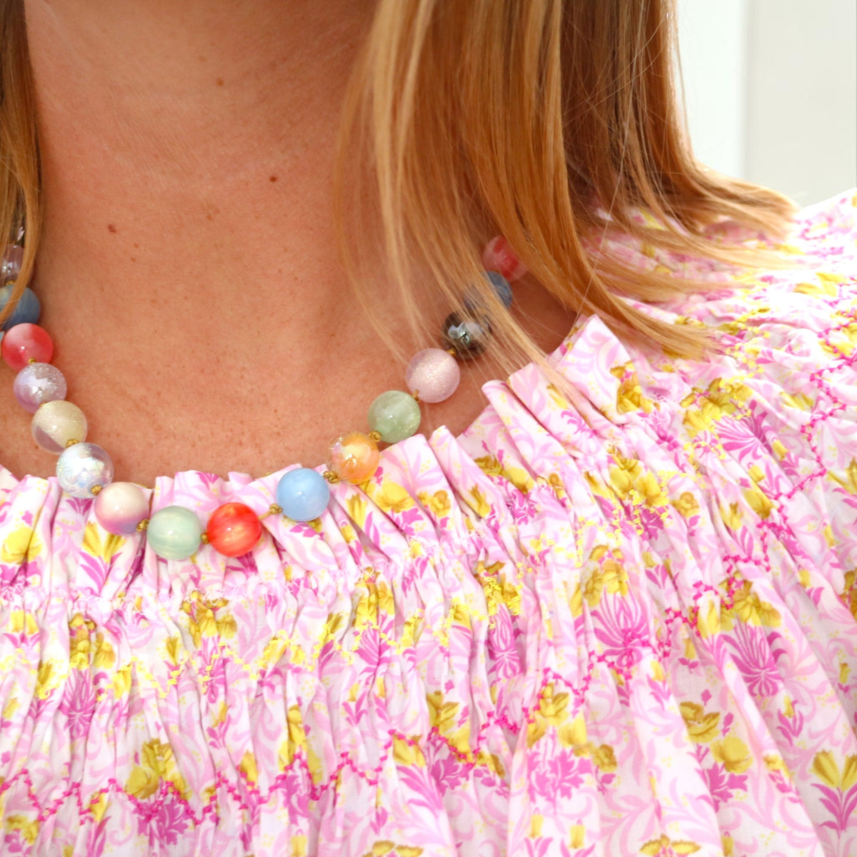 Woman wearing a multicolor Prisma beaded necklace