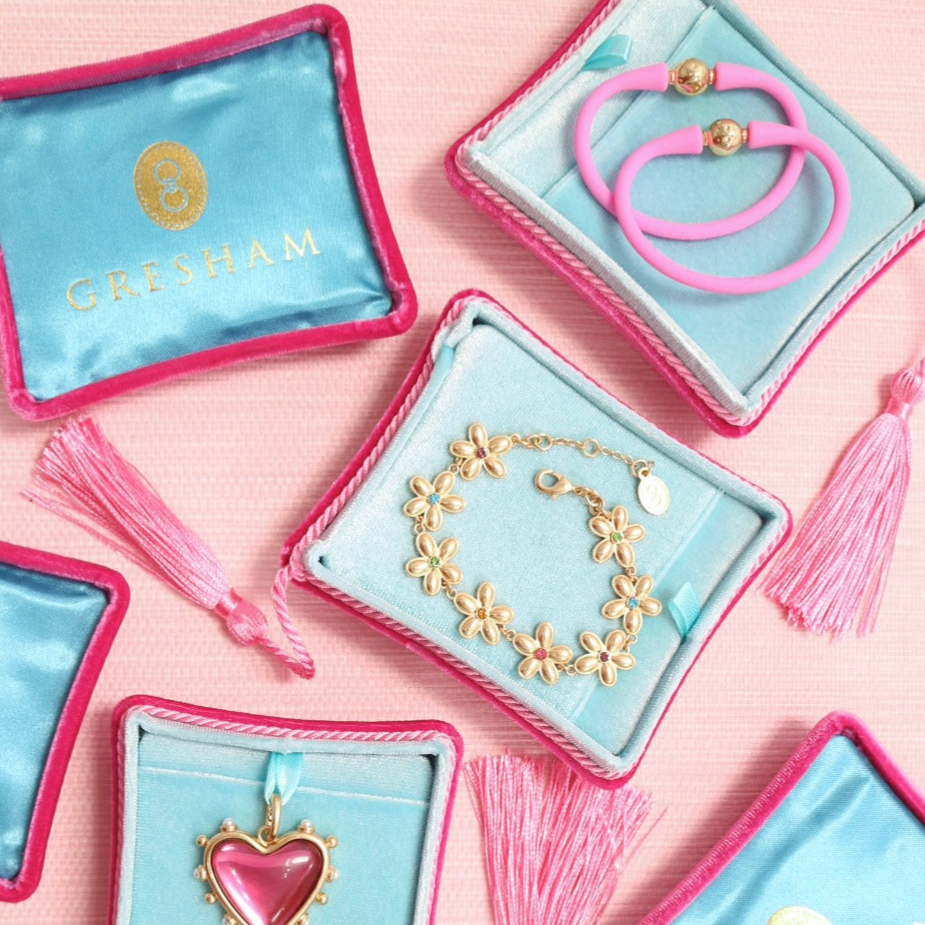 Open travel jewelry boxes with necklaces and earrings inside